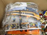 a box full of legos that are sitting on the floor
