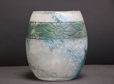 a white vase with a blue and green design on it