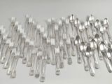 many forks and spoons laid out on the table