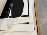 a picture of a black cat sitting on top of a piece of paper