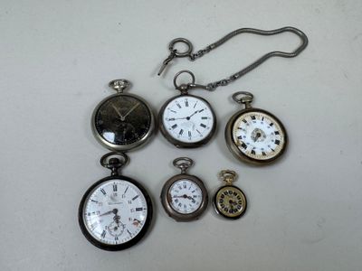 many different types of pocket watches on the table