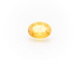 a yellow sapphire stone on a white background