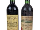 two bottles of wine sitting next to each other on a white surface