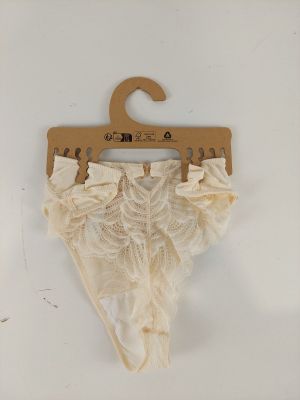 a white panties hanging on a hanger on a wall