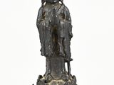 an image of a statue of a woman with a hat and a cane