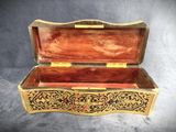 an old wooden box with a decorative design on the inside