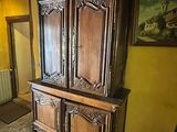a large wooden cabinet in the middle of a room