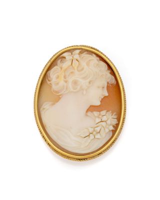 a close up of a woman ' s face in a gold frame
