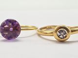 a pair of gold rings with amethorate and diamond
