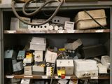 many different types of electrical equipment on the shelves