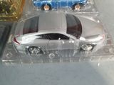 two toy cars that are sitting in a plastic box