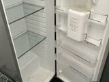 a refrigerator with its door open and the door is empty