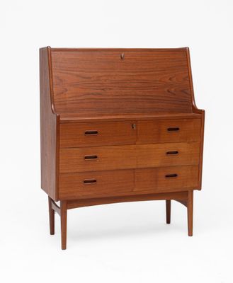 a mid century danish teak secretary ' s desk with drawers