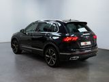the rear end of a black volkswagen suv parked in a room