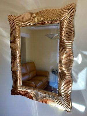 a mirror hanging on the wall in a living room