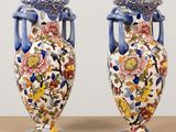 two vases sitting on top of a wooden table next to each other