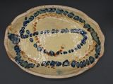 a blue and white plate with a design on it