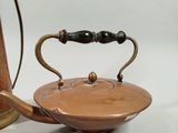 a tea pot and a tea kettle sitting on a table