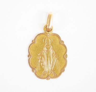 a close up of a gold pendant on a white background