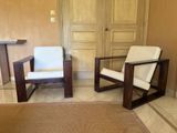 two chairs and a table in a room