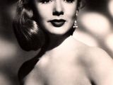 an old black and white photo of a woman in a strapless dress
