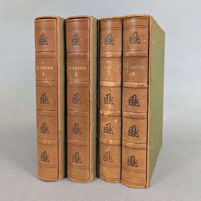 three old books sitting on top of each other on a table