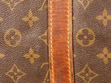 a close up of a brown louis vuitton bag with a brown strap
