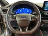 the interior of a car with a steering wheel and a touch screen