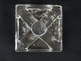 a glass square with a metal design on it