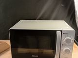 a microwave that is sitting on a wooden table