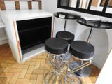 four stools sitting in front of a counter in a kitchen