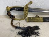 a sword with a tassel on the ground next to it