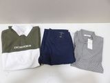 three men ' s polo shirts and pants sitting on a table
