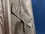 the back of a silver jacket with a zipper on it