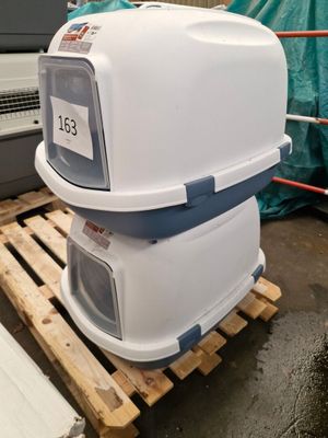 a white and blue toilet sitting on top of a pallet