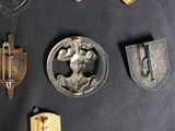 many different types of badges on a black surface