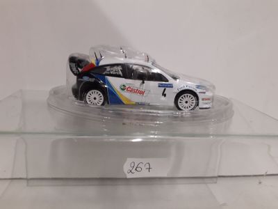 a toy car that is on display on a clear shelf
