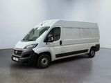 a picture of a white van parked in a large room
