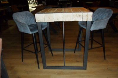 a wooden table with two blue chairs in a restaurant