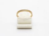 a close up of a gold ring on a white surface