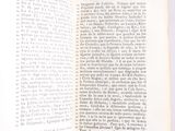 an open book on a white table with a black and white picture