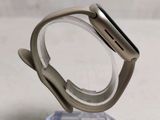 a silver apple watch sitting on top of a clear stand