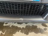 a close up of a car ' s grille with a sticker on it