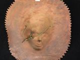 an image of a sculpture of a woman ' s face in a shell