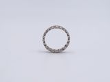 a close up of a silver ring on a white surface