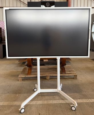 a large flat screen tv on a stand in a warehouse