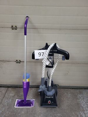 a mop and a mop on the ground next to a garage door