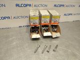 two boxes of screws and a couple of screws on a table