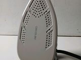 a white iron sitting on top of a white table