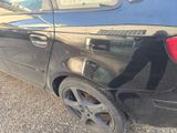 a black car that is parked on the side of the road